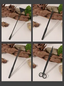Black stainless steel aquarium landscaping tools close-up, including spatula and scissors.