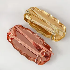Detail view of luxury candle care tool sets featuring gold and rose gold metal trays and tools.