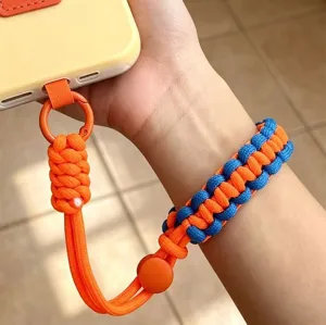 Close-up detail of the colorful woven phone wrist strap, showing adjustable braided cord.