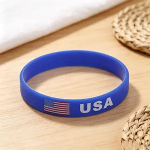 Blue silicone sports wristband with USA flag and text for national team support and events.