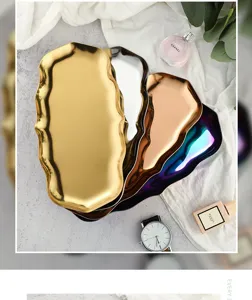 Wavy stainless steel tray, irregular metal jewelry organizer, cosmetic storage plate for home decor.