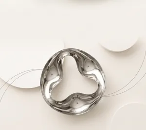 Metal decorative tray with fluid curve design, ideal for aromatherapy and jewelry organization.