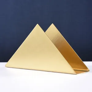 Modern minimalist gold stainless steel triangle napkin holder for dining table decor.
