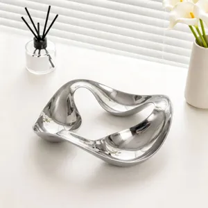 Nordic fluid curved metal tray for jewelry and aroma storage, elegant desktop decor dish.