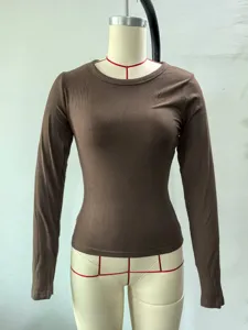 Detail view of brown ribbed long sleeve crewneck slim fit top, showcasing texture and fabric.