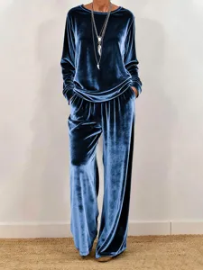 Detailed view of the soft velvet long sleeve top and wide leg pants set in deep blue.