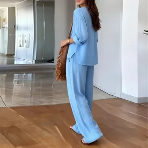 Light blue V-neck casual top and straight trousers matching set detail shot in room.