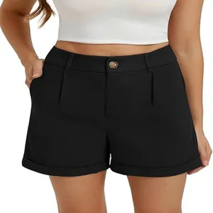 Detailed view of women's black high waisted pleated casual shorts featuring a chic button closure.
