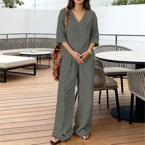 Detail view of the solid V-neck top and loose straight pants casual suit, showcasing tailoring.