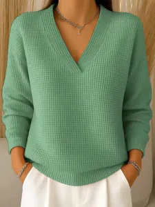Detailed view of the women's green waffle knit V-neck long sleeve top texture and design.