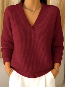 Close-up of women's burgundy waffle knit V-neck sweater, soft texture, elegant daily style.