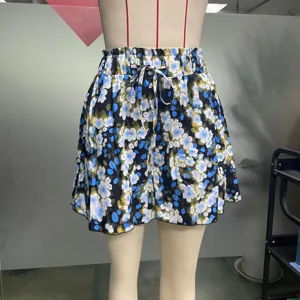 Détail de short taille haute à fleurs avec impression bleue et lien de serrage.
