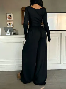 Black long sleeve wide leg jumpsuit for women, casual slim fit solid color design detail.