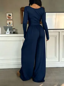 Navy blue long sleeve jumpsuit for women, elegant slim fit high waist wide leg pant set.