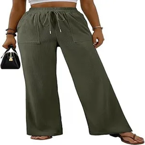 Pantaloni larghi in velluto a coste verdi da donna, vita alta elasticitata e grandi tasche.