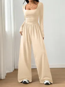 Long sleeve square neck solid color wide leg jumpsuit detail view showing stylish fit.