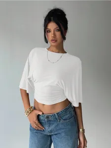 Close-up detail shot of womens casual solid white cropped top, soft and breathable fabric.