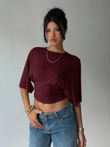 Detailed view of the burgundy waist-cinching short sleeve top, stylish regular shoulder design.
