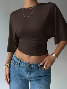 Detail view of the stylish brown short-sleeve crop top featuring trendy waist cinched design.