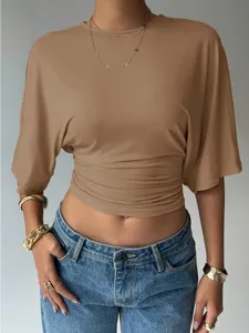 Close-up detail of the stylish khaki crop top featuring ruched waist and casual short sleeves.