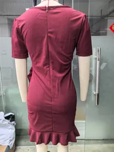 Detailed back view of a solid maroon short-sleeve bodycon dress with ruffle hem.
