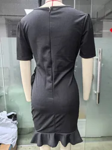Elegant black slim fit short sleeve mini dress with mermaid hem and back zipper detail.
