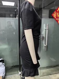 Detailed side view of a stylish black slim fit short sleeve midi dress with ruffle hem.