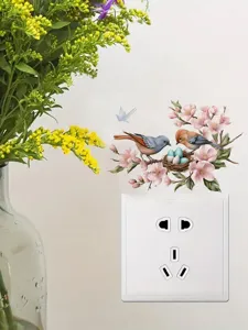 Close-up detail of a charming PVC wall switch sticker featuring bird, nest, and cherry blossoms.