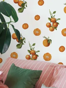 Orange wall stickers detail view showcasing fresh fruit and leaf patterns for bedroom decoration.