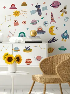 Detailaufnahme von bunten Weltall Wandtattoos mit Planeten und Raketen auf weißer Wand.