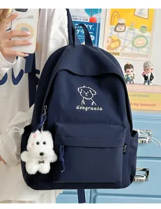 Dark blue canvas student school backpack with cute dog embroidery and plush pendant detail.