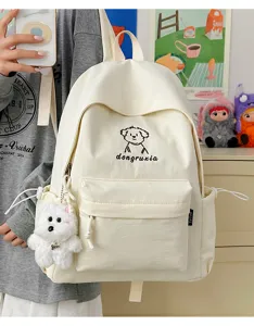 Large capacity white canvas school backpack with cute puppy embroidery and plush pendant for students.