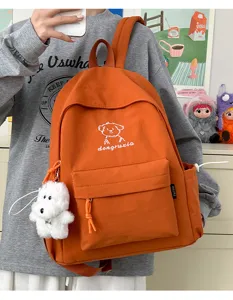 Cute orange student backpack with adorable puppy embroidery and plush pendant for daily use.