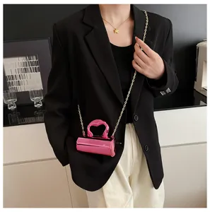 Stylish minimalist shiny pink cylindrical shoulder crossbody mini bag detail view showcasing sleek design