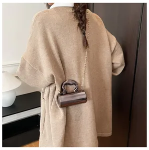 Glossy PVC cylinder crossbody bag for women, trendy mini shoulder bag with chain strap.