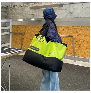 Large capacity 73L colorblock duffel bag detail, stylish streetwear shoulder bag for travel.