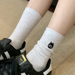 Cute women's mid-tube socks featuring a sweet black cat embroidery and colorful speckles.