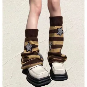 Detail shot of knitted striped leg warmers featuring sparkling sequin star patches.