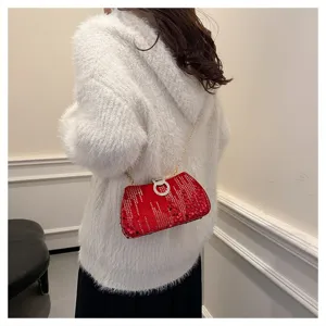 Red sequin evening clutch bag detail, stylish chain strap and sparkling rhinestone ring buckle.