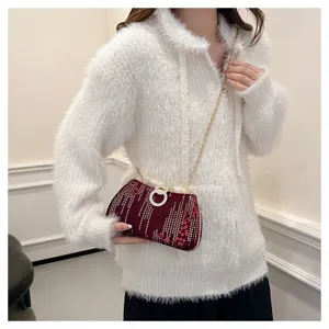 Red sequin clutch bag with metallic chain strap and diamond ring clasp for evening party.