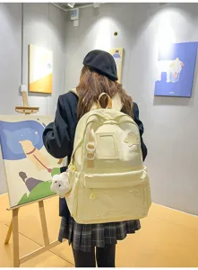 Details of the Japanese Harajuku style yellow student backpack with a clear front pocket and star patch.