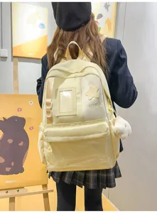 Detail view of Japanese Harajuku style student backpack with transparent front pocket and charm.