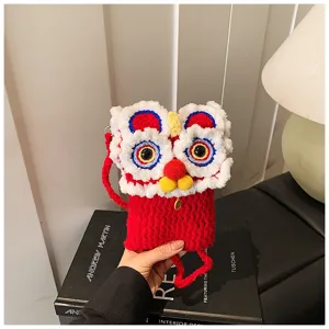 Close-up detail of the cute Chinese lion dance knit crossbody phone bag, featuring soft yarn craftsmanship.