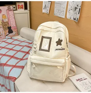 Detail view of cream school backpack with transparent front pocket and cute star patch.