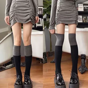 Close-up detail shot of Japanese style color-blocked knee high socks in black and grey.
