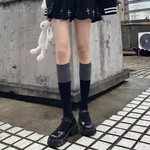 Close-up shot of Japanese JK contrast color knee-high socks paired with platform Mary Janes.