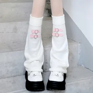 Close-up detail of white knitted leg warmers with pink heart buckle straps for JK style Y2K.
