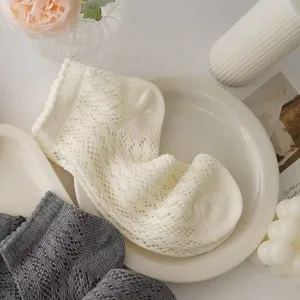 Detailed view of summer thin mesh lace short socks in white and grey, sweet hollow design.