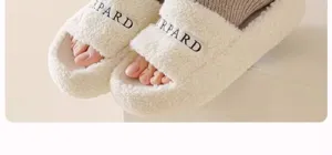 Detailed close-up view of cozy plush fuzzy slippers paired with warm grey knit socks.