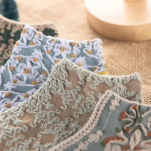 Vintage court relief short socks detail, delicate knitted floral texture, breathable comfort.